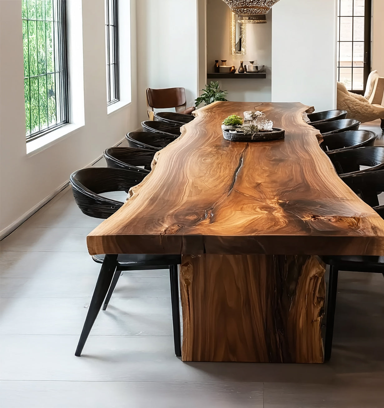 Modern dining room with a large natural wood slab table surrounded by black chairs