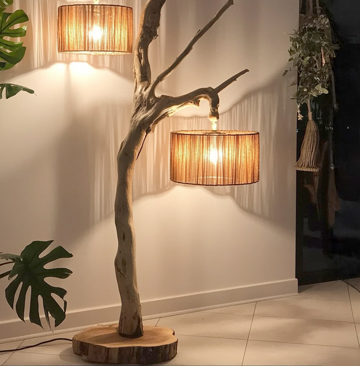 Modern wooden floor lamp with natural tree branch design and warm fabric lampshade in cozy room
