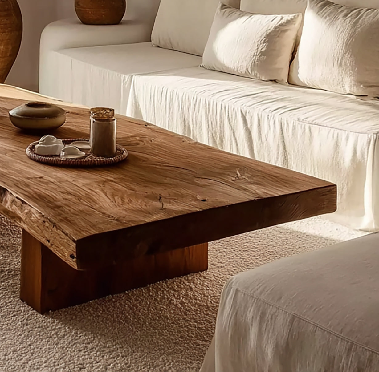 Living room with rustic wooden coffee table, beige linen sofa, and textured carpet