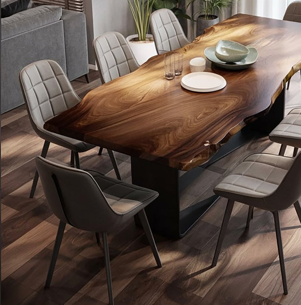 Modern dining room with live edge wooden table and six gray padded chairs on wood flooring