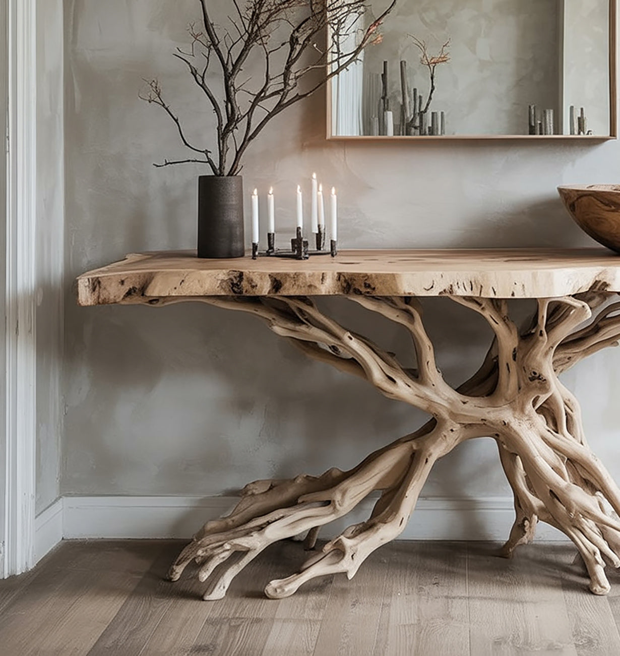 Decorative wooden table with intricate root-like base, candle holder, and vase with branches in modern room
