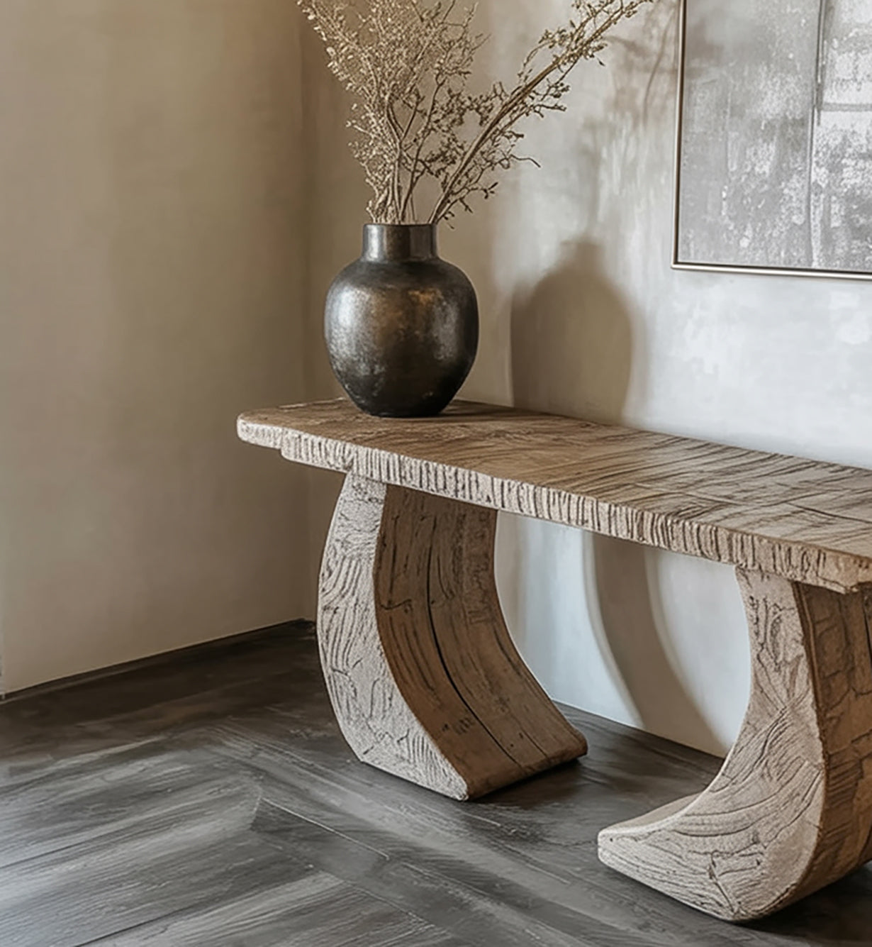 Rustic wooden bench with sculptural curved legs and dark vase with dried branches on gray floor